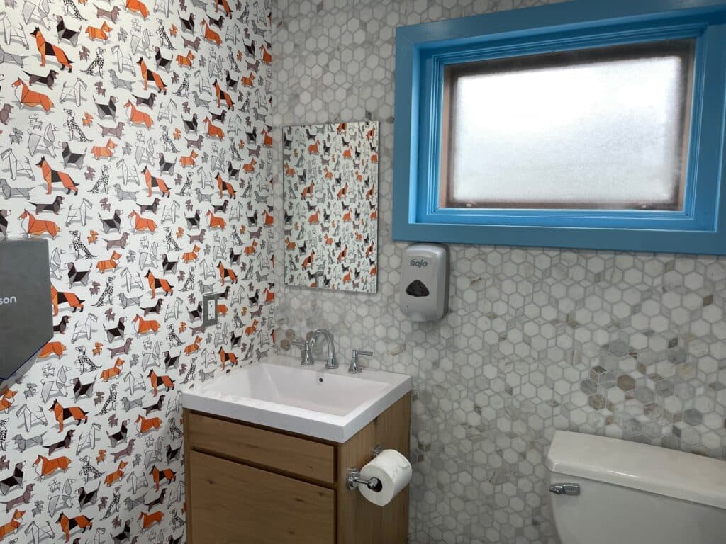 A photo of a bathroom with "dog" wallpaper